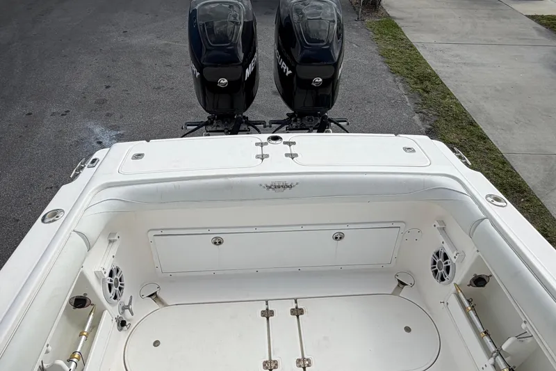 Slide: The Image of 1997 Wellcraft 302 Scarab Sport boat with dual Mercury engines, viewed from the rear deck. - 14