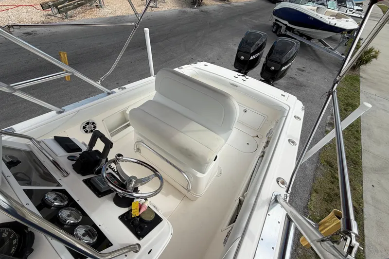 Slide: The Image of 1997 Wellcraft 302 Scarab Sport boat cockpit with dual Mercury engines and steering console. - 21