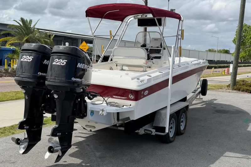 Slide: The Image of 1997 Wellcraft 302 Scarab Sport boat with twin Mercury 225 engines on a trailer. - 24