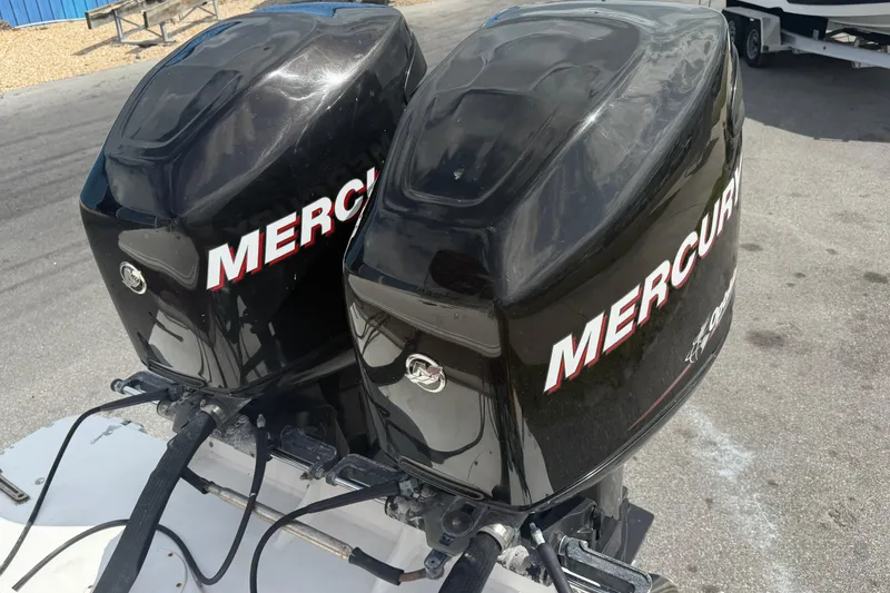Slide: The Image of Twin Mercury outboard engines on a 1997 Wellcraft 302 Scarab Sport boat. - 4