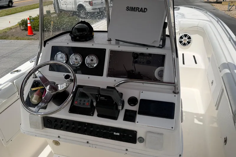 Slide: The Image of 1997 Wellcraft 302 Scarab Sport boat dashboard with steering wheel and navigation equipment. - 6