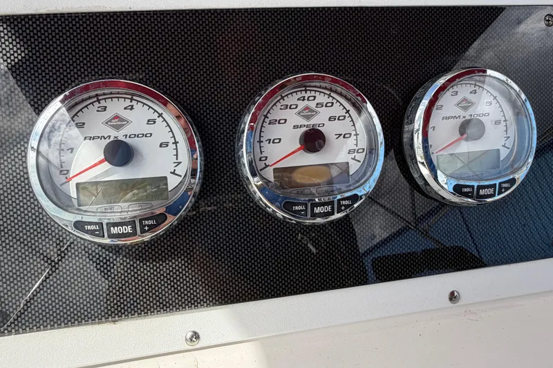 Slide: The Image of Dashboard gauges of a 1997 Wellcraft 302 Scarab Sport boat, displaying RPM and speed. - 9