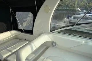 Slide: The Image of 2004 Sea Ray Sundancer 260 helm with gauges, steering wheel, and fire extinguisher. - 10