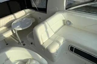 Slide: The Image of 2004 Sea Ray Sundancer 260 helm with gauges, steering wheel, and seating area. - 13