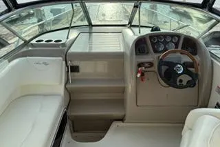 Slide: The Image of 2004 Sea Ray Sundancer 260 cabin interior with window and cushioned seating. - 14