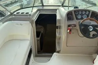 Slide: The Image of Interior of 2004 Sea Ray Sundancer 260 boat with kitchenette and seating area. - 15
