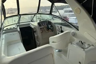 Slide: The Image of Interior of 2004 Sea Ray Sundancer 260, featuring kitchenette and seating area. - 17