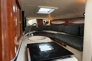 Slide: The Image of 2004 Sea Ray Sundancer 260 boat on land, surrounded by trees and other boats. - 21