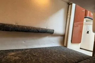 Slide: The Image of Engine compartment of a 2004 Sea Ray Sundancer 260 boat, showcasing mechanical components. - 22