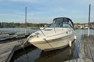 Slide: The Image of 2004 Sea Ray Sundancer 260 boat interior with white seating and steering console. - 3