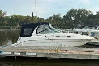 Slide: The Image of 2004 Sea Ray Sundancer 260 boat interior with white seating and helm area. - 4