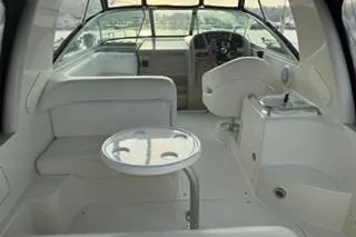 Slide: The Image of Interior of 2004 Sea Ray Sundancer 260 boat, featuring white seating and sleek design. - 7