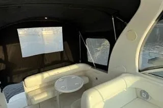 Slide: The Image of 2004 Sea Ray Sundancer 260 cockpit with steering wheel, dashboard, and seating. - 8