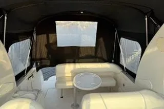 Slide: The Image of 2004 Sea Ray Sundancer 260 boat interior with white seating and helm station. - 9