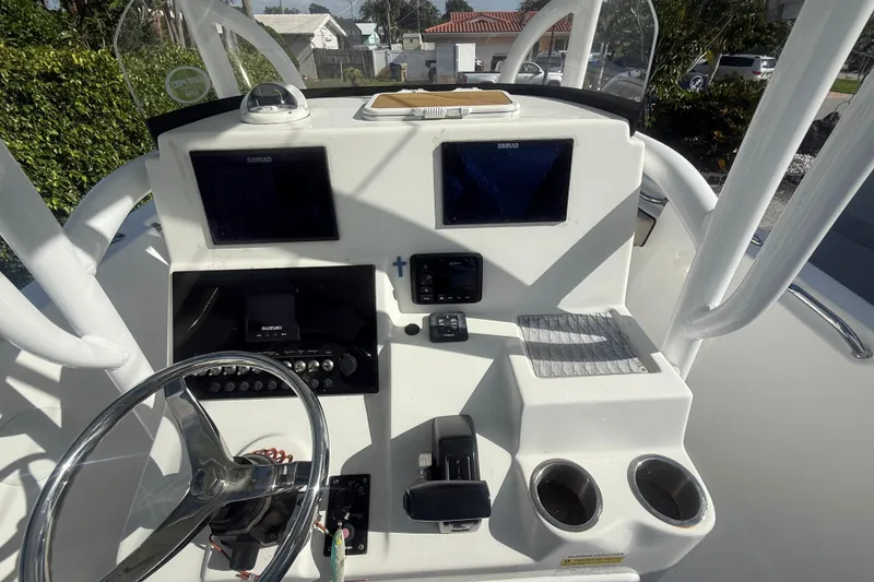 Slide: The Image of 2023 Sea Pro 219 Deep V CC boat dashboard with steering wheel and navigation displays. - 11