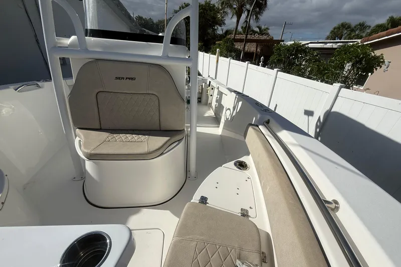 Slide: The Image of 2023 Sea Pro 219 Deep V CC boat interior with cushioned seating and white deck. - 17