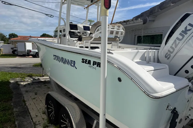 Slide: The Image of 2023 Sea Pro 219 Deep V CC boat with Suzuki engine, parked outdoors. - 3