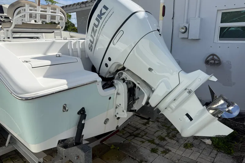 Slide: The Image of 2023 Sea Pro 219 Deep V CC with Suzuki outboard motor, parked on a trailer. - 5