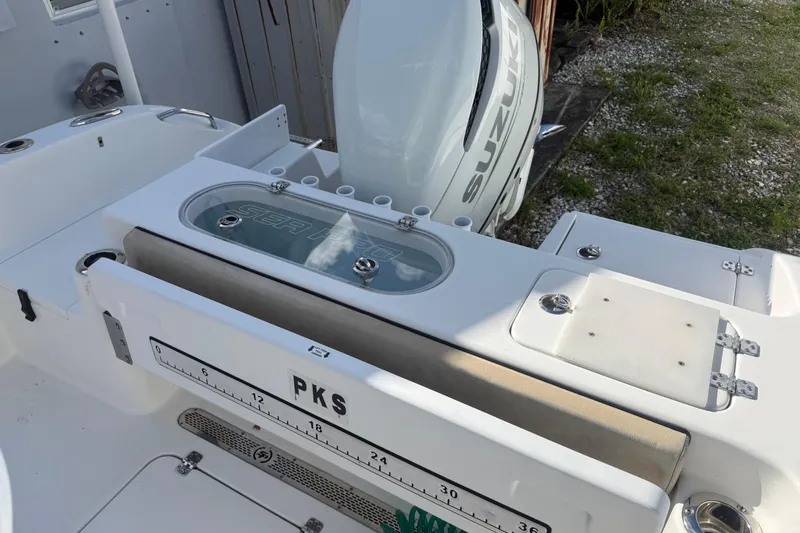 Slide: The Image of 2023 Sea Pro 219 Deep V CC boat with Suzuki engine, featuring a livewell and measuring board. - 7