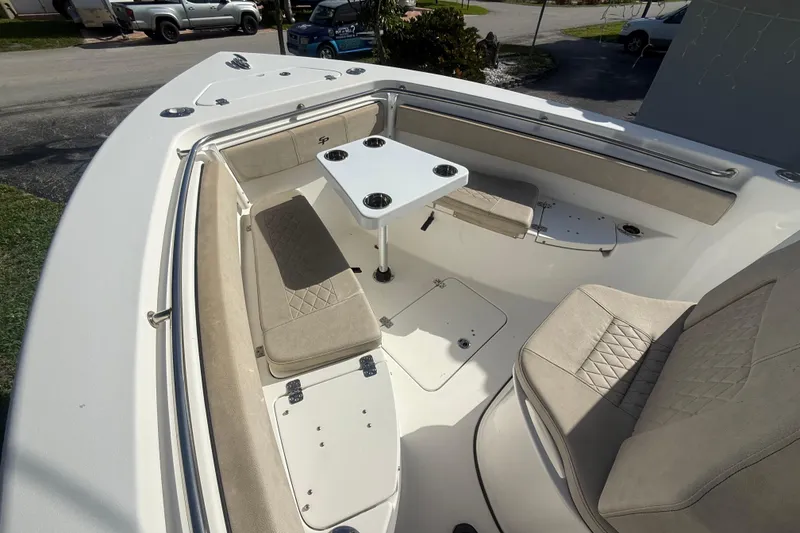 Slide: The Image of 2023 Sea Pro 219 Deep V CC boat interior with seating and table setup. - 9