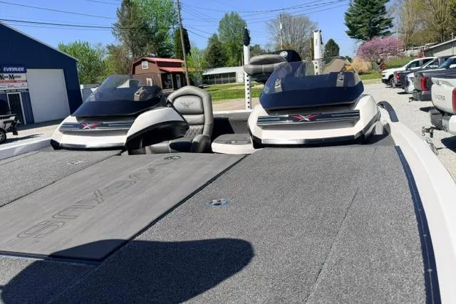 Slide: The Image of 2022 Vexus VX21 boat with dual consoles and spacious deck in outdoor setting. - 11