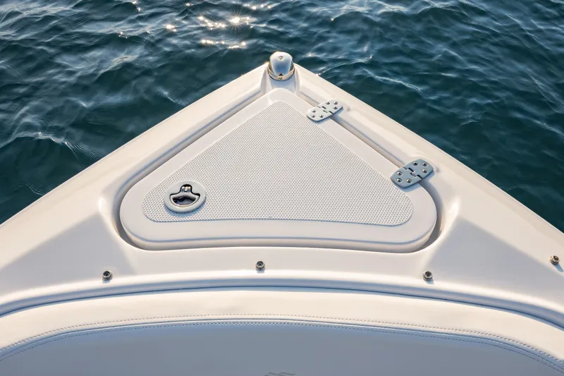 Slide: The Image of Bow of 2026 Four Winns H2 OB boat on water, featuring sleek design and hatch. - 26