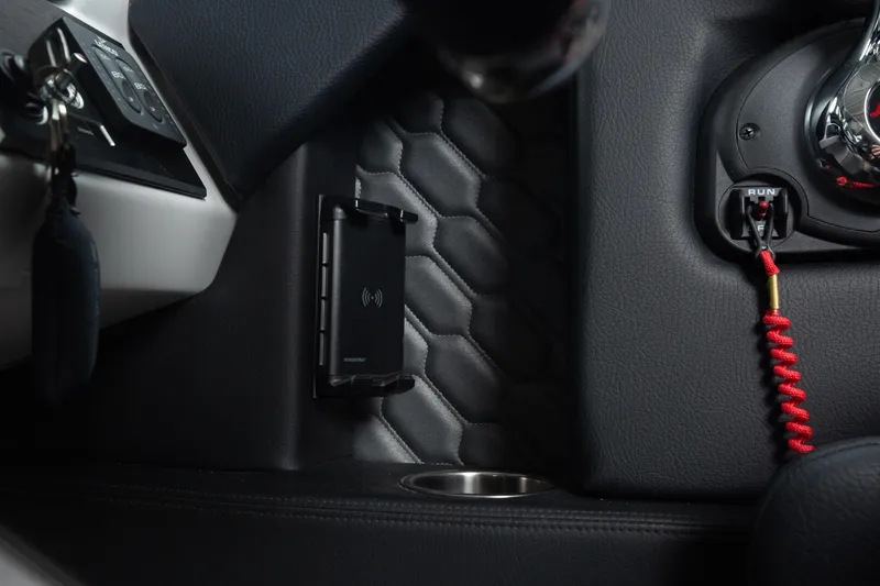 Slide: The Image of Interior of 2026 Four Winns H2 OB boat with wireless charging pad and ignition switch. - 11