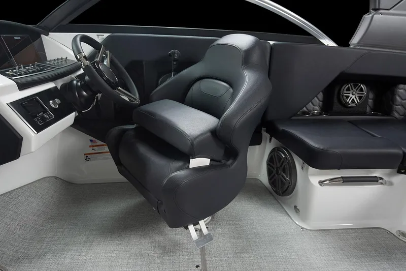 Slide: The Image of Manufacturer Provided Image: 2025 Four Winns H2 OB boat interior with black captain's chair and modern dashboard. - 12