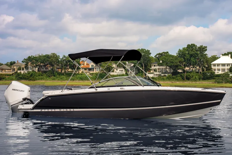 The Image of 2026 Four Winns H2 OB boat on calm water with scenic background. - 0