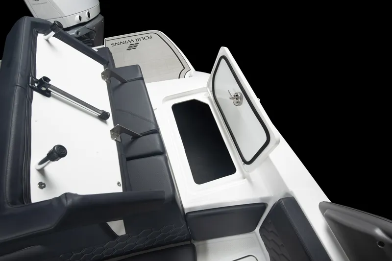 Slide: The Image of 2026 Four Winns H2 OB boat interior with open storage compartment and seating. - 17