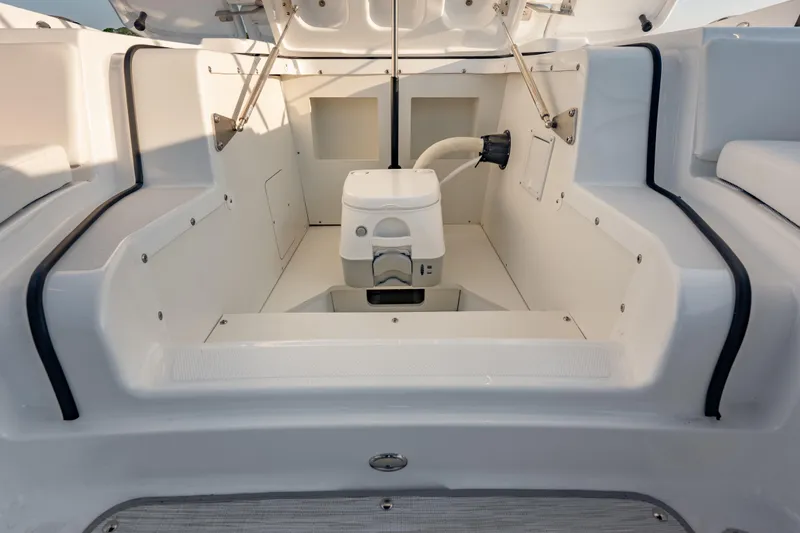 Slide: The Image of Interior view of 2026 Four Winns H2 OB boat, showcasing seating and storage compartments. - 32
