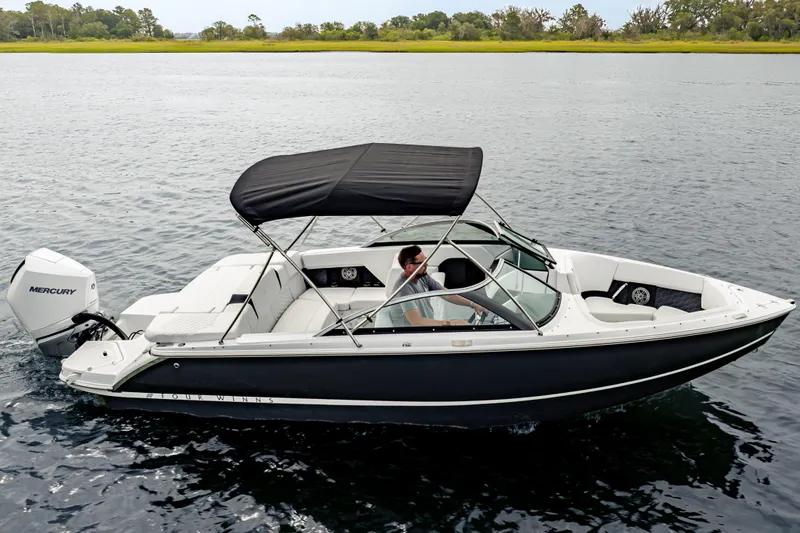 Slide: The Image of 2026 Four Winns H2 OB boat with Mercury engine on calm water. - 1