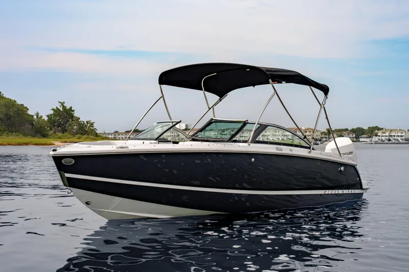 Slide: The Image of 2026 Four Winns H2 OB boat on calm water with canopy. - 8