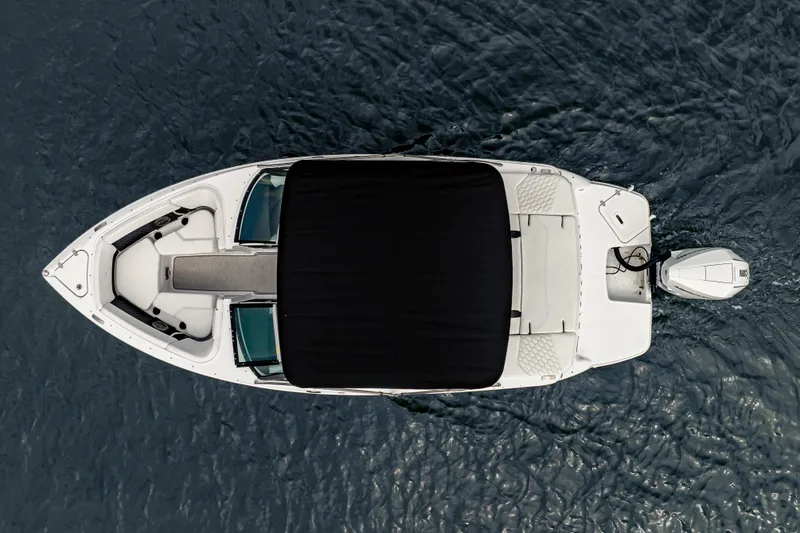 Slide: The Image of Aerial view of 2026 Four Winns H2 OB boat on water, featuring sleek design and outboard motor. - 7