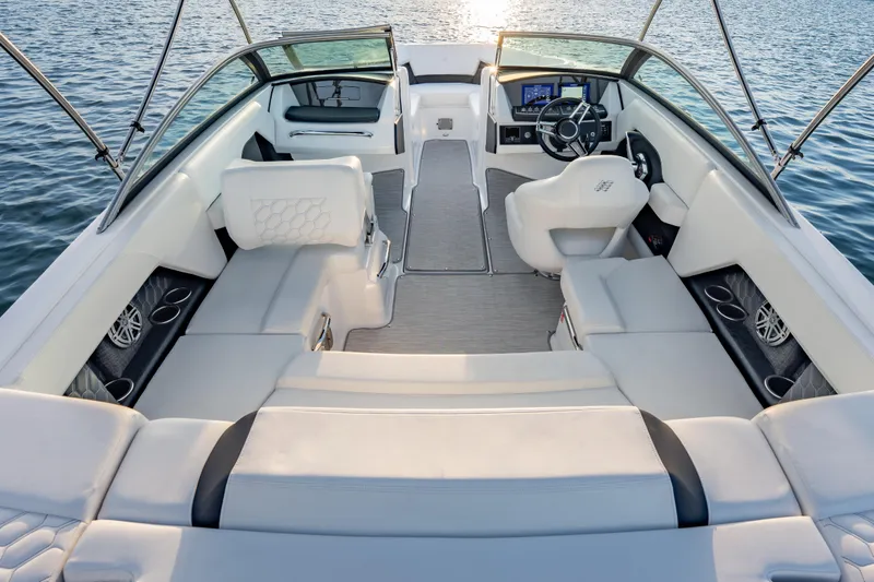 Slide: The Image of 2026 Four Winns H2 OB boat interior with luxurious seating and modern dashboard on water. - 19