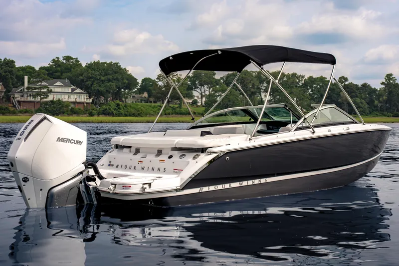 Slide: The Image of 2026 Four Winns H2 OB boat with Mercury outboard engine on a serene lake. - 3