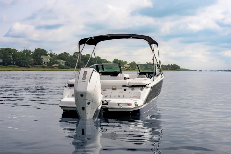 Slide: The Image of 2026 Four Winns H2 OB boat on calm water with scenic background. - 5