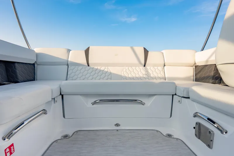 Slide: The Image of 2026 Four Winns H2 OB boat interior with white seating and blue sky background. - 30