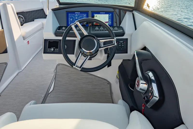 Slide: The Image of 2026 Four Winns H2 OB boat cockpit with modern steering and navigation displays. - 23