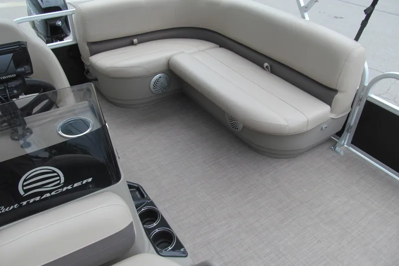 Slide: The Image of 2021 Sun Tracker Bass Buggy 16 XL interior with beige seating and cup holders. - 10