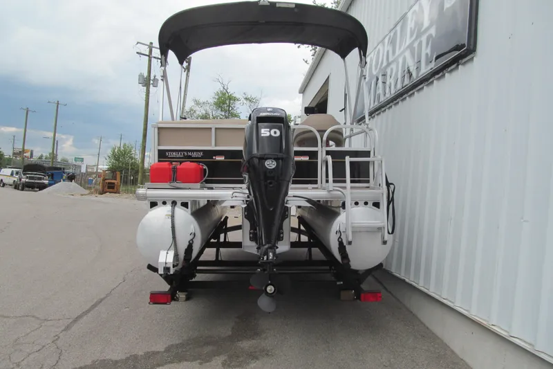 Slide: The Image of 2021 Sun Tracker Bass Buggy 16 XL pontoon boat with outboard motor, parked outside. - 3