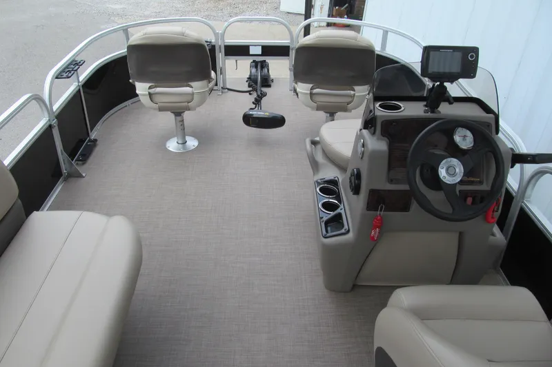 Slide: The Image of 2021 Sun Tracker Bass Buggy 16 XL pontoon boat interior with steering console and seating. - 4