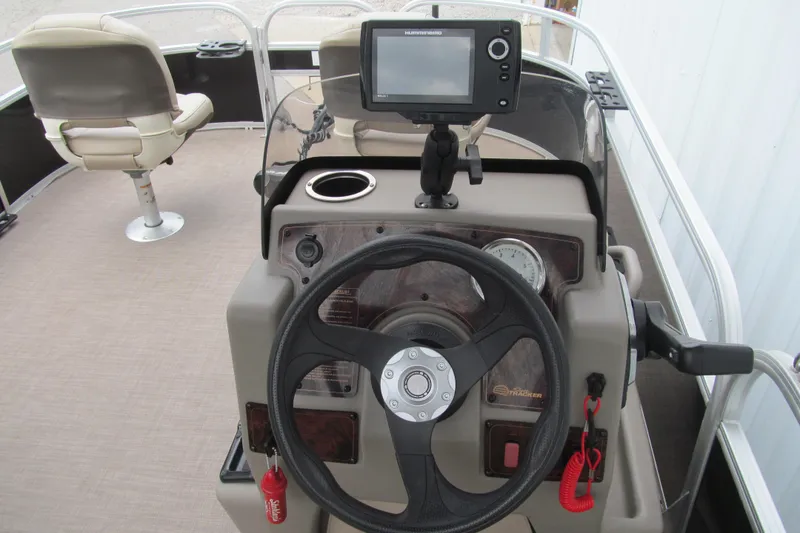 Slide: The Image of 2021 Sun Tracker Bass Buggy 16 XL boat console with steering wheel and navigation system. - 5