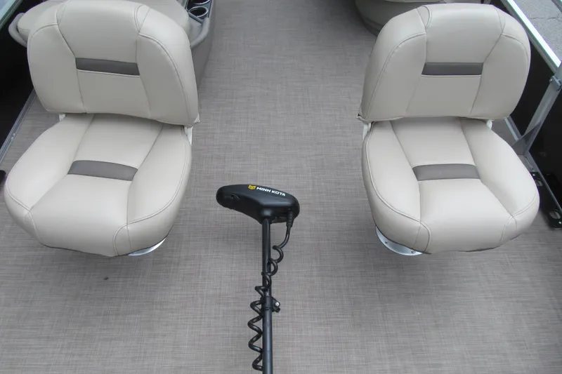 Slide: The Image of 2021 Sun Tracker Bass Buggy 16 XL interior with two beige seats and a trolling motor. - 8