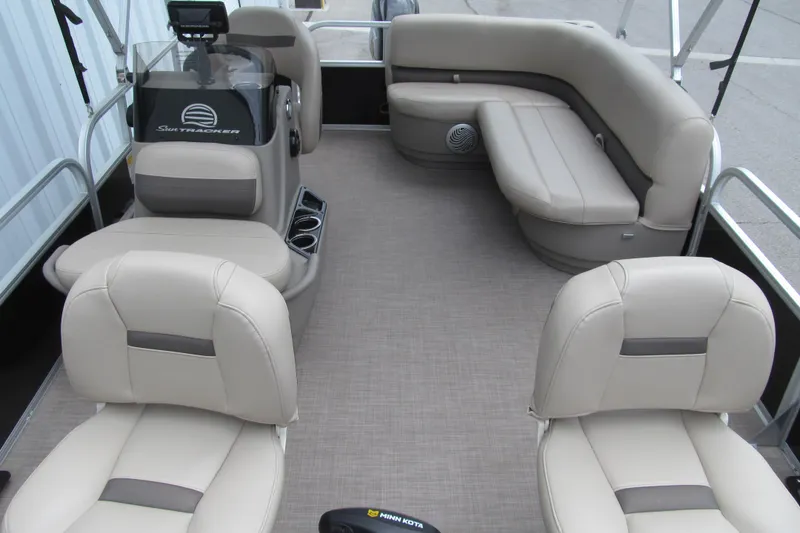 Slide: The Image of 2021 Sun Tracker Bass Buggy 16 XL pontoon boat interior with beige seating and console. - 9
