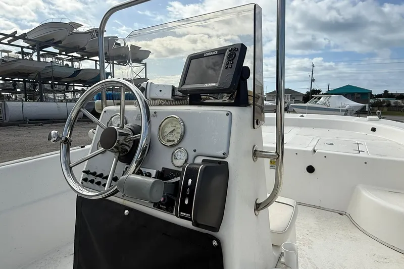 Slide: The Image of 2009 Carolina Skiff 198 DLV boat console with steering wheel and navigation equipment. - 15