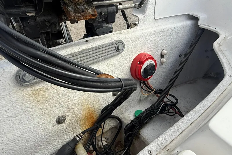 Slide: The Image of 2009 Carolina Skiff 198 DLV boat interior showing wiring and battery switch. - 17