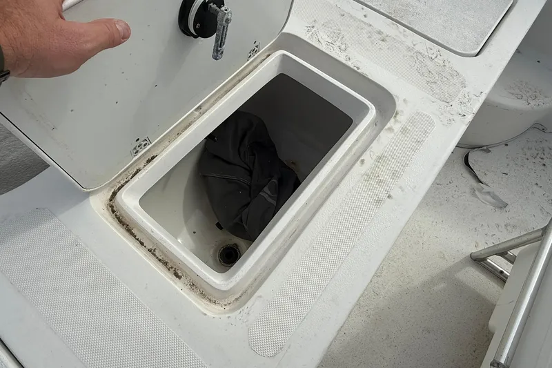 Slide: The Image of Storage compartment on a 2009 Carolina Skiff 198 DLV boat, showing interior details. - 18