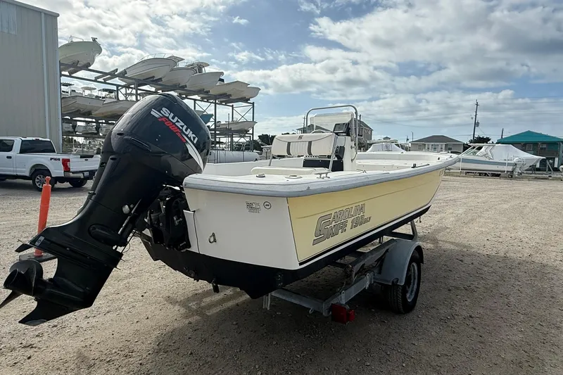 Slide: The Image of 2009 Carolina Skiff 198 DLV boat with Suzuki outboard motor on trailer. - 6
