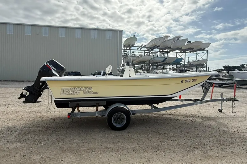 Slide: The Image of 2009 Carolina Skiff 198 DLV boat on trailer, parked outdoors. - 7